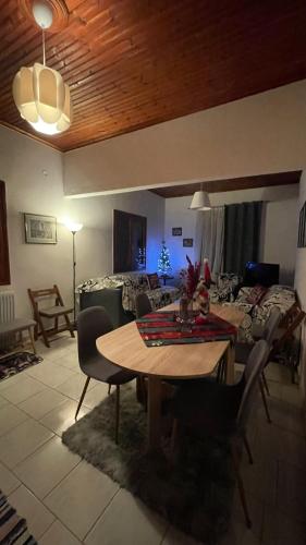 a living room with a table and a couch at My Sweet Home in Tríkala