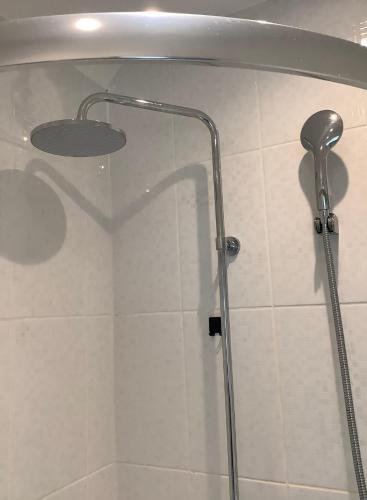 a shower with a glass door in a bathroom at Lorton Villa with a Log Burner in Saint Helens
