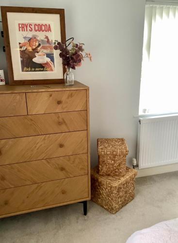 a dresser and a chair in a bedroom at Lorton Villa with a Log Burner in Saint Helens
