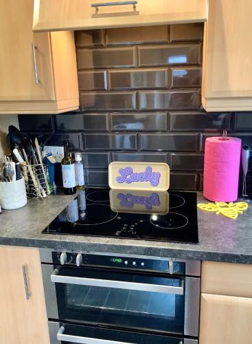 a kitchen with a stove with a box on it at Lorton Villa with a Log Burner in Saint Helens