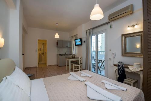 a room with a bed and a kitchen with a table at Diamond Apartments & Suites in Hersonissos