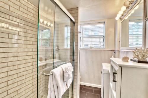 a bathroom with a shower with a glass door at Friendly Native 204 in St Pete Beach