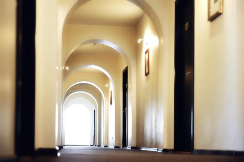 an empty hallway with arches in a building at Old Town Hotel Bohema, Klaipėda in Klaipėda