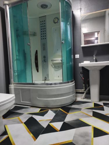 a bathroom with a shower and a sink at Sky loft house in Almaty