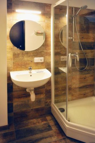 a bathroom with a sink and a shower at Old Town Hotel Bohema, Klaipėda in Klaipėda