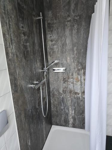 a bathroom with a shower with a curtain at Gasthof Einhaus in Borken