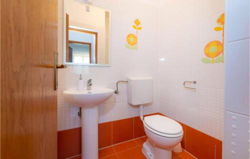 a bathroom with a toilet and a sink at 5 Bedroom Lovely Home In Posedarje in Posedarje