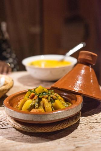 a bowl of food on top of a table at Jnane Allia in Douar Soukkane