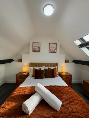 a bedroom with a large bed with two white legs on it at St Helens House Incredible Location with Parking & Garden in Oxford