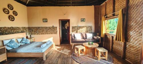 a living room with a couch and a table at Agandi Uganda Eco-lodges in Bwindi