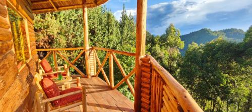 a balcony of a cabin with a view of trees at Agandi Uganda Eco-lodges in Bwindi