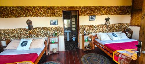 a bedroom with two beds in a room at Agandi Uganda Eco-lodges in Bwindi