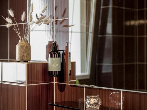 two bottles sitting on a counter in a bathroom at Apparthotel "Landhaus Veronika" in Mayrhofen