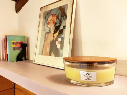 a candle sitting on a counter next to a picture at "La casetta" indipendente, con ampio spazio verde in Fontechiari