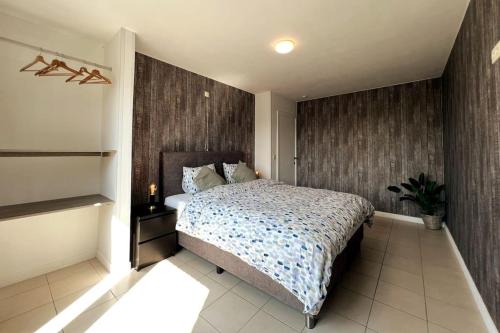 a bedroom with a large bed in a room at Bright, spacious apartment nearby beach in Ostend