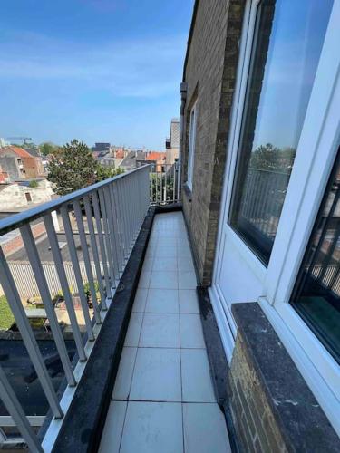 a balcony of a house with a window at Bright, spacious apartment nearby beach in Ostend