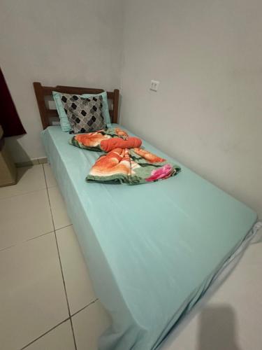 a bed in a room with a blue mattress at Pousada Moranga in Carolina