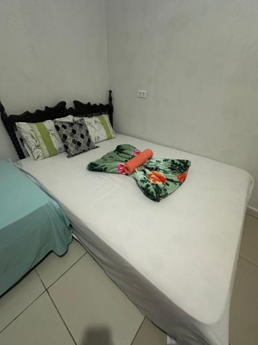 a bed with two pillows sitting on top of it at Pousada Moranga in Carolina