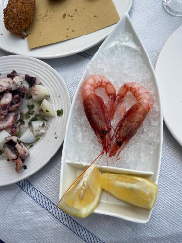 a plate of food with a shrimp in the shape of a heart at Villa Sofia *Luxury experience in Calabria in Zambrone