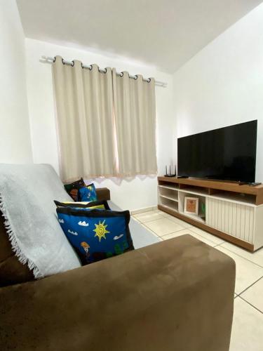 a living room with a flat screen tv and a couch at Ap da Thay - Os Três Pandeiros in Campina Grande
