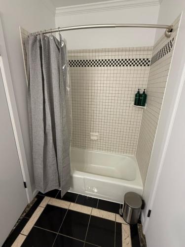 a small bathroom with a shower and a tub at Luxury Boutique Home - 4 Beds 1 Baths 25 minutes to NYC in Jersey City