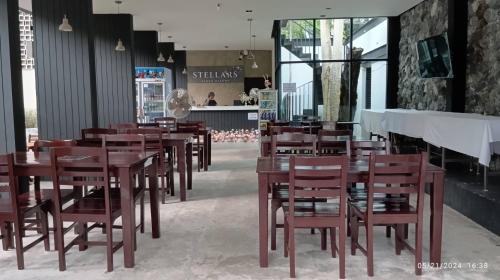 a dining room with wooden tables and chairs at Stellars Samed Resort in Ko Samed