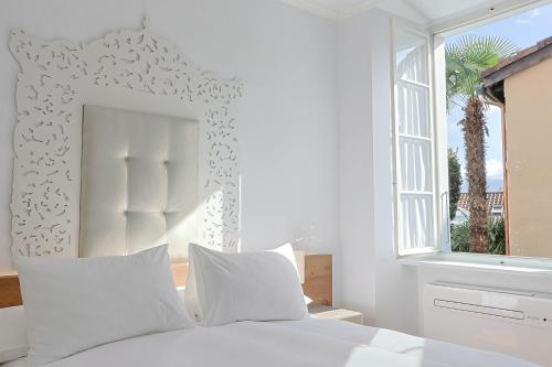Postel nebo postele na pokoji v ubytování Caffè dell'Arte Boutique Rooms Locarno