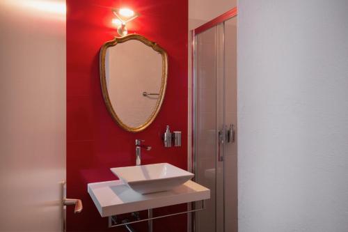 a bathroom with a sink and a mirror at Caffè dell'Arte Boutique Rooms Locarno in Locarno