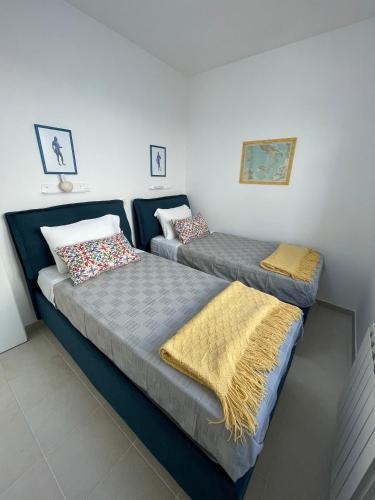 two beds sitting next to each other in a room at Villa Sofia *Luxury experience in Calabria in Zambrone