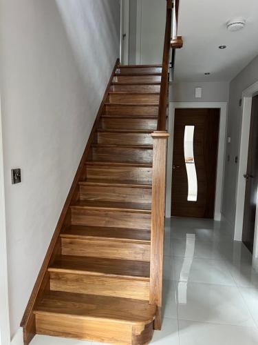 a wooden staircase in a house with a door at Holiday Home in Leap in Leap