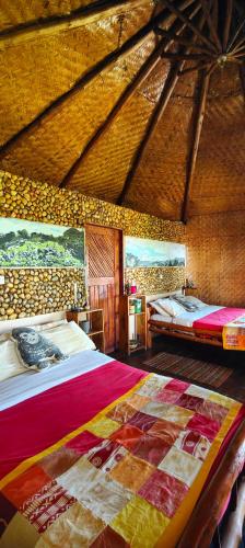 a large room with two beds and a bathroom at Agandi Uganda Eco-lodges in Bwindi