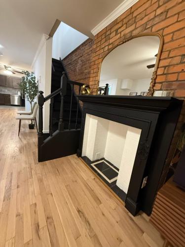 a living room with a fireplace and a mirror at Luxury Boutique Home - 5 Beds 2 Baths 25 minutes to NYC in Jersey City