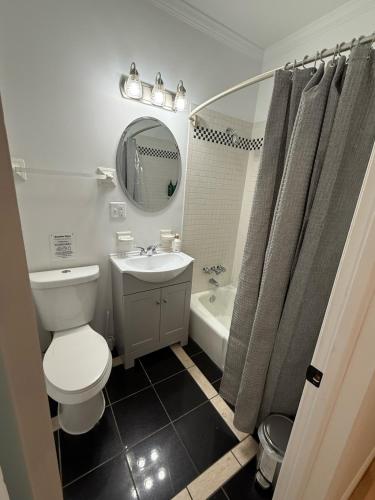 a bathroom with a toilet and a sink and a tub at Luxury Boutique Home - 5 Beds 2 Baths 25 minutes to NYC in Jersey City