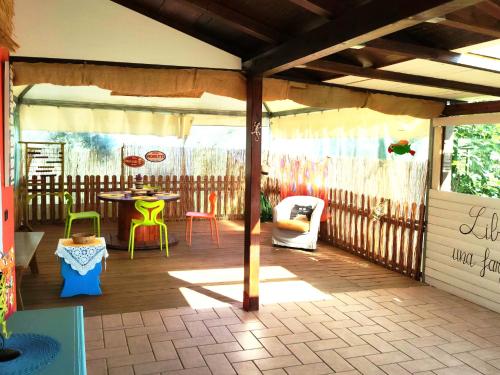a pavilion with a table and chairs on a patio at "La casetta" indipendente, con ampio spazio verde in Fontechiari