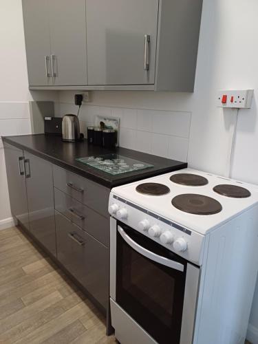 a white stove top oven in a kitchen at Home from Home in Faversham