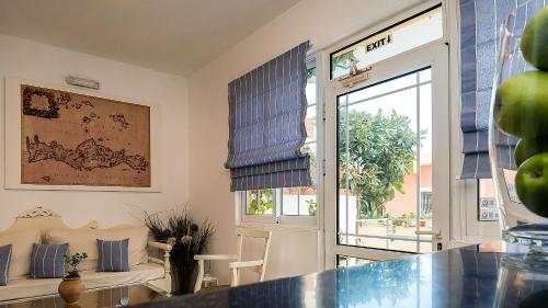 a living room with a door and a window at Diamond Apartments & Suites in Hersonissos