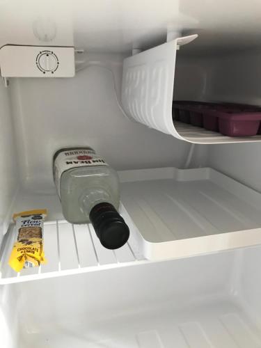 a bottle of mayonnaise sitting in the drawer of a refrigerator at Suite Garage in Ingeniero Maschwitz