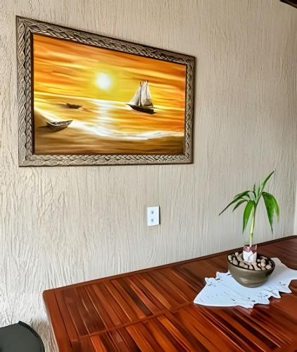 a painting of a sailboat on a painting on a wall at Acesso à Praia Ar Condicionado Conforto Garantido! in Saquarema