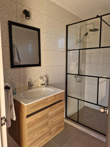 a bathroom with a sink and a glass shower at Entre Quebradas y Loicas in Algarrobo