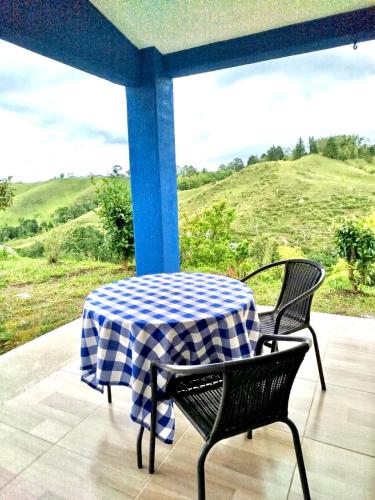 a blue and white checkered table and chairs on a porch at Green Highland Casa Campestre in Pereira