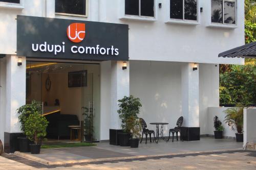a building with a sign that reads udi controllers at Udupi Comforts in Udupi