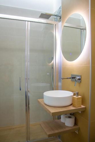 a bathroom with a sink and a mirror at WANDERLUST SPACCANAPOLI Points Of View in Naples