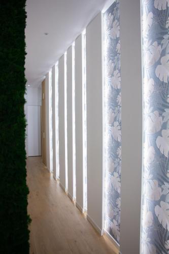 a hallway with blue and white wallpaper at WANDERLUST SPACCANAPOLI Points Of View in Naples