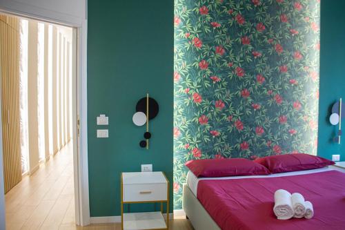a bedroom with a bed and a floral wall at WANDERLUST SPACCANAPOLI Points Of View in Naples