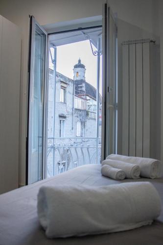 a bedroom with a bed with a view of a building at WANDERLUST SPACCANAPOLI Points Of View in Naples
