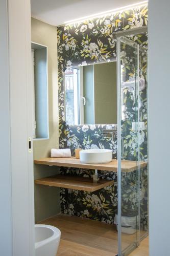 a bathroom with a sink and a mirror at WANDERLUST SPACCANAPOLI Points Of View in Naples