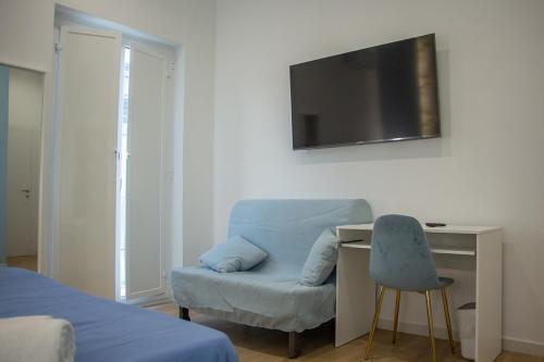 a bedroom with a desk and a chair and a television at WANDERLUST SPACCANAPOLI Points Of View in Naples