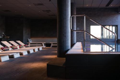 a row of benches in a room with a pool at Frösö Park Hotel in Östersund