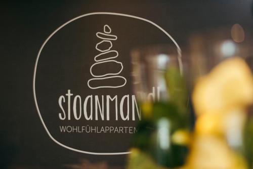 a picture of a sign for a restaurant with a sandwich at stoanmandl Wohlfühlappartements in Neustift im Stubaital