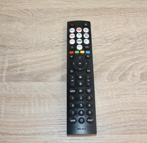 a remote control sitting on top of a wooden table at The One Malpensa Rooms in Vizzola Ticino